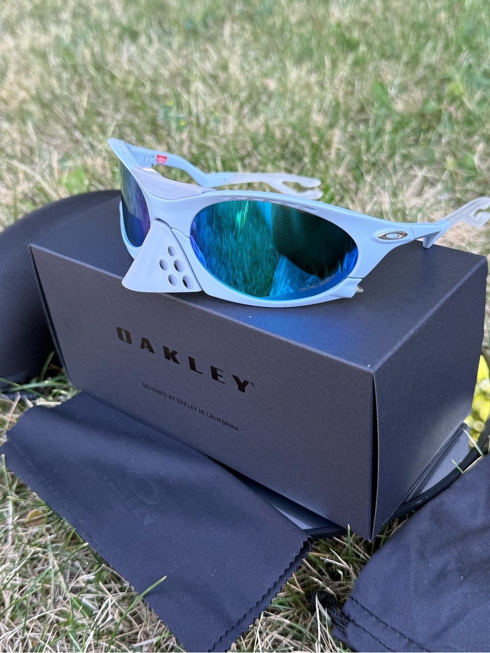 Oakley White Frame Sunglasses with Blue-Green Mirrored Lenses